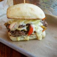 Division Philly · Thin sliced NY strip, grilled peppers, and onions, white American cheese, aioli on ciabatta.