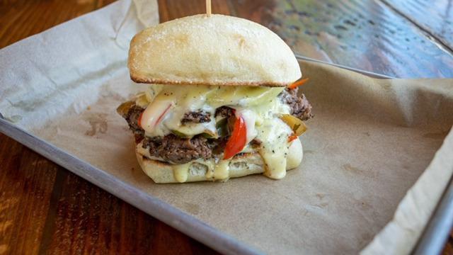 Division Philly · Thin sliced NY strip, grilled peppers, and onions, white American cheese, aioli on ciabatta.