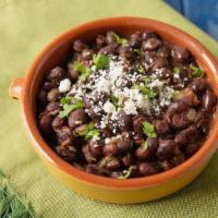 Side Black Beans · Slow cooked black beans stewed in a mixture of chipotle pepper, garlic, onion and our signat...
