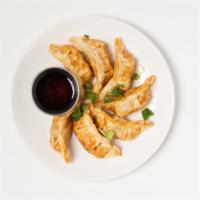 Gyoza (7) · crispy chicken dumplings with house soy sauce vinaigrette.