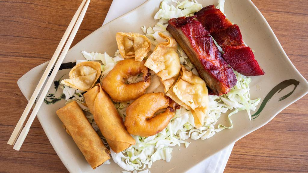 Meat Combination Appetizer · Two egg rolls, two fried shrimp, two BBQ ribs, two crab puffs, and two fried wontons.
