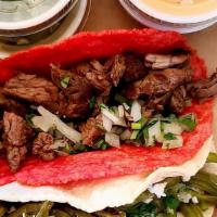 Carne Asada · Marinated tender juicy beef served on a flaming hot cheeto tortilla. All tacos come with cil...