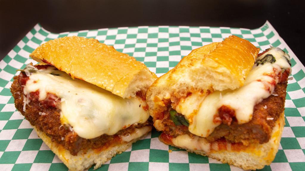 Spicy Sausage Marinara · Breaded and fried spicy ground pork, house red sauce, aged mozzarella, parm and basil.