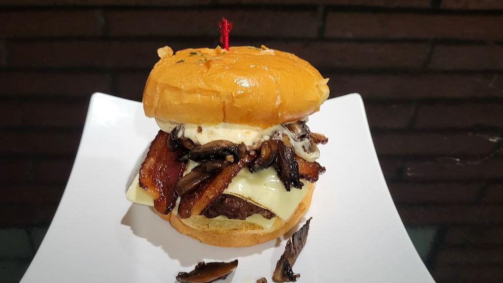 Mushroom Bacon Swiss Burger · 1/3 All beef patty served on brioche bun, sauteed mushrooms, caramelized onions, house bacon, swiss cheese and savory mayo. Includes choice of chip.