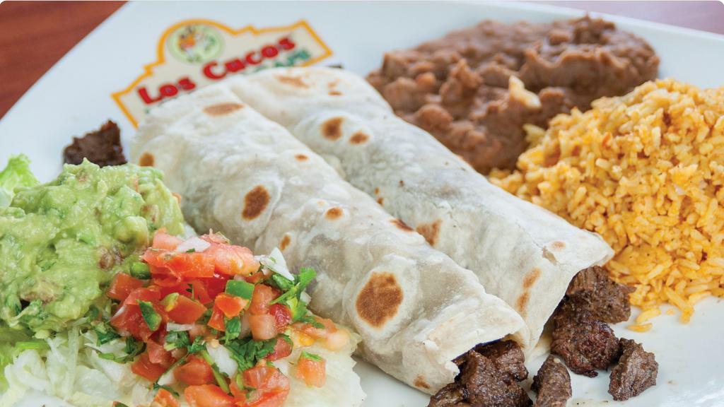 Fajita Tacos · (2) Large flour tortillas filled with your choice of beef or chicken fajitas, served with chile con queso on the side, rice, beans, guacamole, and pico de gallo.
