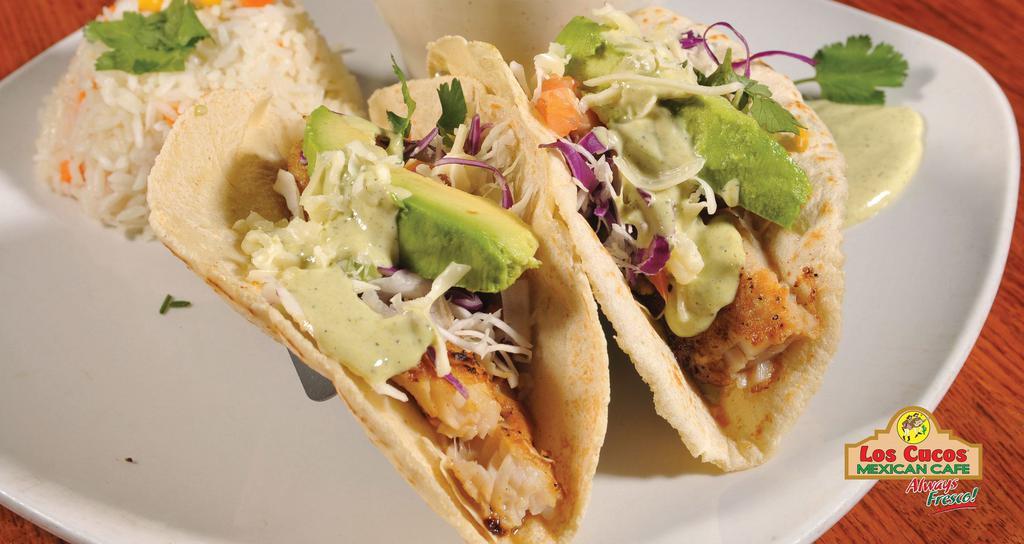 Fish Tacos · (2) Hand-made corn tortillas, delicious grilled fish, shredded green and red cabbage, cheese and special lemon creamy sauce.