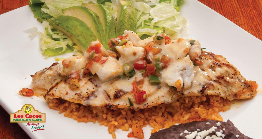 Fish Playa Azul · Grilled tilapia fish fillet served on a bed of rice and topped with crab meat, lemon butter sauce, and pico de gallo. Served with avocado.