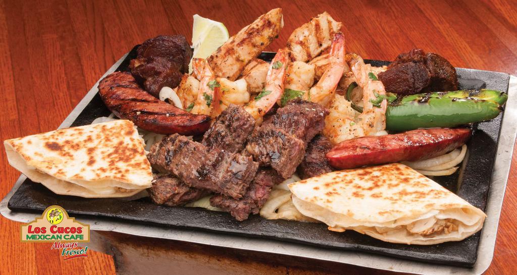 Parrilla San Luis · Beef and chicken fajitas, carnitas, jalapeño sausage, grilled shrimp, chicken quesadillas, and molcajete sauce. Served with rice, beans, pico de gallo, tortillas, guacamole, and side of chihuahua cheese.