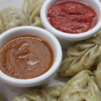 Veggie Momo · VEGAN, steamed dumplings filled with veggies. Served with VEGAN dipping sauce.