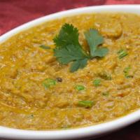 Baigon Bharta · Gluten-free. Puréed fire roasted eggplant cooked with green peas, spices, and cream, topped ...