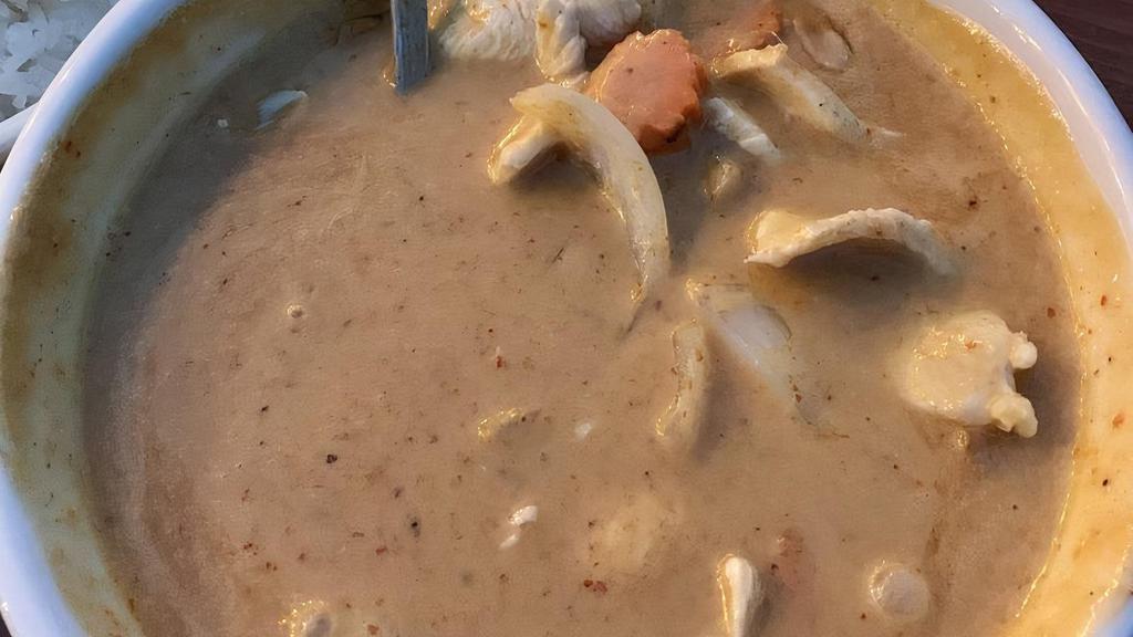 Massaman Curry · With coconut milk, white onions, carrots, potatoes and peanuts.