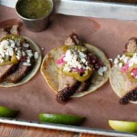 Three Brisket Tacos · Choice of salsa verde or salsa roja, pickled jalapeño, red onion, queso fresco,. lime wedges...