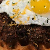 Chicken & Waffles · Maple glazed fried chicken atop a golden waffle, Cheddar cheese and topped with a sunny side...