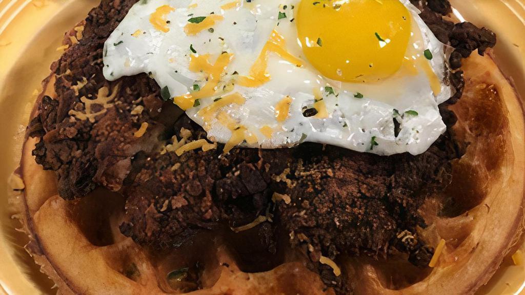 Chicken & Waffles · Maple glazed fried chicken atop a golden waffle, Cheddar cheese and topped with a sunny side up egg.