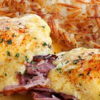 Eggs Benedict · Grilled ham atop an English muffin, topped with 2 eggs and smothered in hollandaise sauce. S...