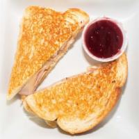 Grilled Monte Cristo · Fresh turkey, black forest ham, Swiss cheese, spread with our house mayo, Dijon mustard, and...