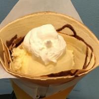 Ice Cream Crepe · Vanilla ice cream, whip cream and chocolate syrup in a crepe.