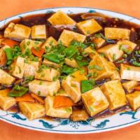 Ma Po Tofu · Hot and spicy. Steamed tofu and ground pork slow-cooked in hot bean sauce.
