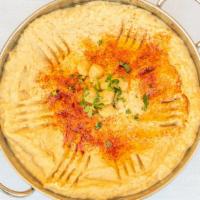 Hummus · A blend of chickpeas puree with garlic lemon juice and tahini. Served with a drizzle of oliv...
