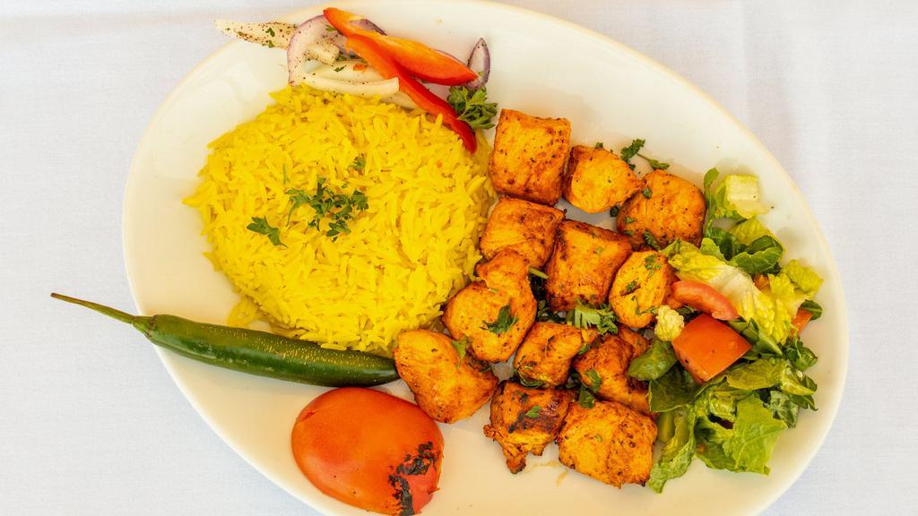 Chicken Tikka · Marinated chicken cubes in yogurt lemon juice and special spices charbroiled and served over rice, salad, pickles.