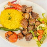 Lamb Tikka · Tender lamb cubes charbroiled to perfection. Served over rice, salad and pickles.