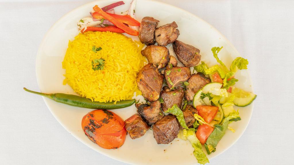 Lamb Tikka · Tender lamb cubes charbroiled to perfection. Served over rice, salad and pickles.