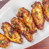 Chicken Wings · Gluten free. Spicy marinated chicken wings (6 pieces) baked in clay oven.
