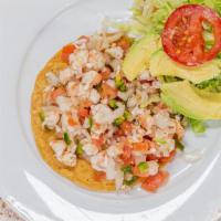 Tostada De Ceviche · A shrimp ceviche tostada.

These items may be served raw or undercooked or may include raw o...