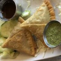 Meat Samosa · Crisp pastry filled with ground lamb, peas and spices, and deep-fried.
