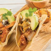 Pulpo Tacos · Octopus sautéed with fried onions and peppers. Topped with avocado and queso fresco. Served ...