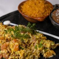 Huevos A La Mexicana  · Scrambled eggs mixed with tomato, chile serrano, onion,  rice, beans and corn or flour torti...