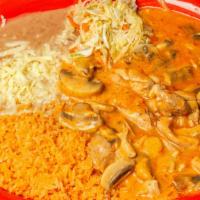 Pollo Chipotle · Tender sliced chicken breast sautéed with mushrooms and covered with chipotle sauce.