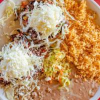  Sopes · Two thick small fried tortillas layered with refried beans. choice of: of: asada, pastor, gr...