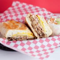 Alicias Cuban Sandwich · Slow wood smoked pork and ham, smoked Swiss cheese, yellow mustard, and pickle on a butter b...