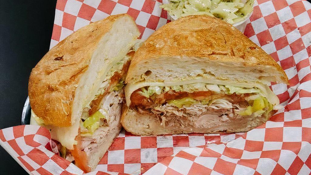Real Turkey On Ciabatta · House smoked real turkey breast, hardwood smoked provolone cheese, tomato, lettuce, red onion, pepperoncini, French dijon, and balsamic marsala vinaigrette, on a Grand Central Bakery Artisan Ciabatta. Comes with one free side.