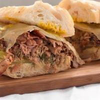 Alicia'S Cuban Sandwich · Slow wood smoked pork and ham, smoked Swiss cheese, yellow mustard, and pickle on a butter b...