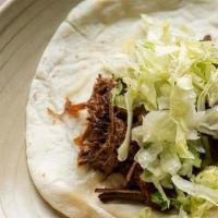 Kids Brisket Taco · Kid taco with cheese, smoked brisket and shredded lettuce.