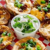 Potato Skins · Loaded with green onions, cheese and bacon. Served with sour cream.