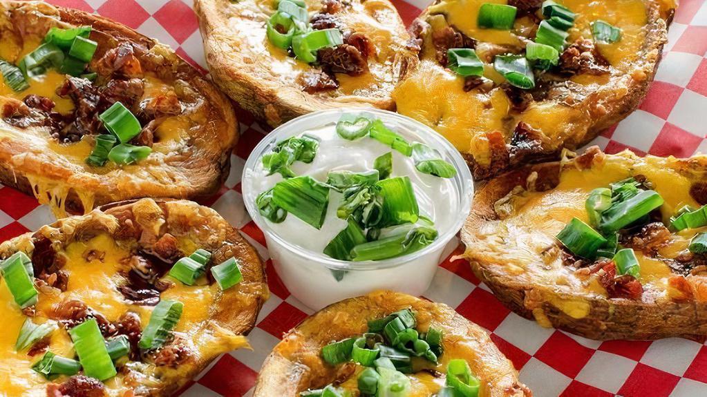 Potato Skins · Loaded with green onions, cheese and bacon. Served with sour cream.