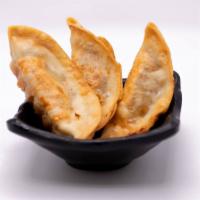 Mandoo · Three pieces of chicken potstickers.