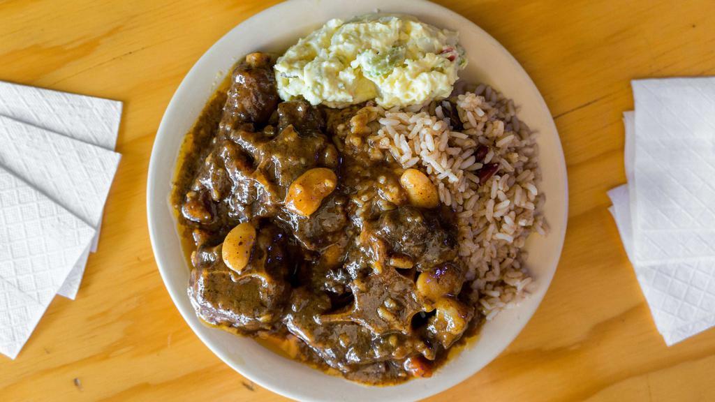 Beef Oxtails Stew · Oxtails simmered in a savory brown gravy, with butter beans and carrots.