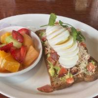 Avocado Toast · Toasted seed lovers bread topped with fresh avocado, tomatoes, Parmesan cheese, bacon, cilan...