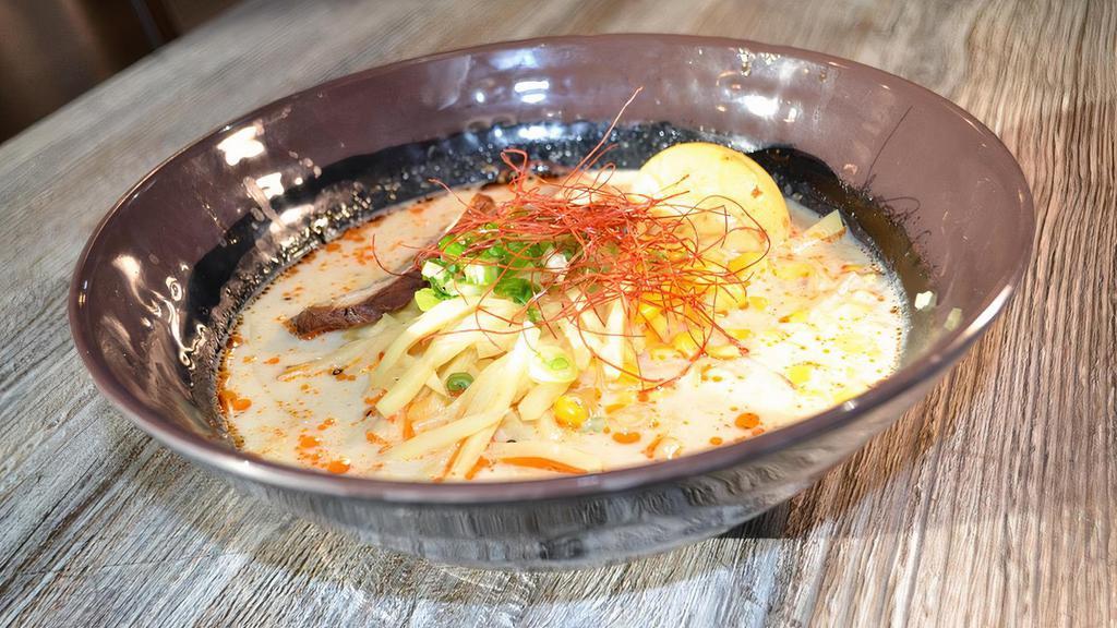 Tonkotsu · Special pork broth, marinated boiled egg, red chili oil, dried shredded chili, black fungus, sweet corn, and green onions.