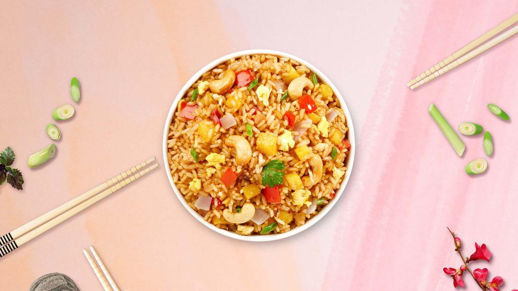 Pineapple Fried Rice · Stir-fried rice served with chicken, shrimp, egg, cashew nut, pineapple chunks, tomato and onion.