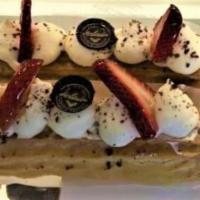 Strawberries & Cream Eclair · Filled with strawberry infused pastry cream and topped with homemade whipped cream and a fre...