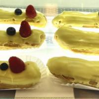 Lemon Raspberry Eclair · Tangy lemon curd and pureed raspberry infused pastry cream, topped with fondant and fresh fr...