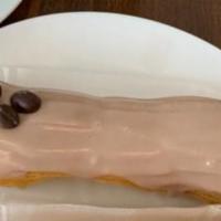 Coffee Eclair · Filled with Cafe Ibis coffee infused pastry cream and topped with fondant.