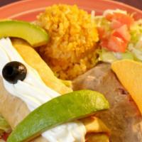 Chicken Chimichanga Plate · Chicken and cheese wrapped inside a deep fried burrito-topped with sour cream and sliced avo...