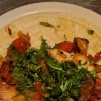 Fish Taco · Made with a soft corn tortilla filled with cilantro, grilled tomatoes  and onion.