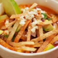 Tortilla Soup · Heart warming Chicken Soup cooked in house, topped with tortilla strips, avocado slices and ...